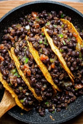 Delicious black bean tacos served with fresh toppings and cilantro