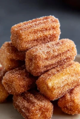 Healthy baked churro bites topped with cinnamon sugar served on a plate