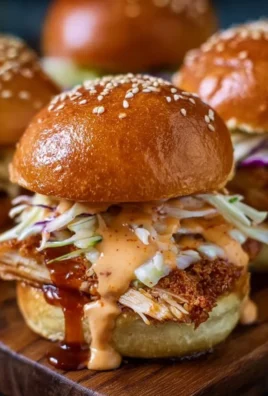 Bang Bang Chicken Sliders served on a platter with fresh ingredients and sauces