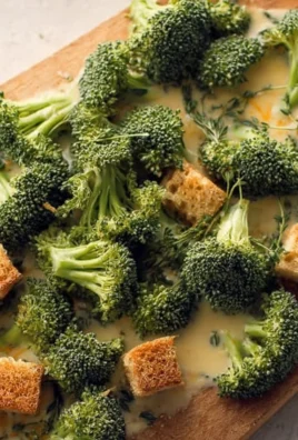 Creamy broccoli cheddar soup garnished with fresh broccoli florets
