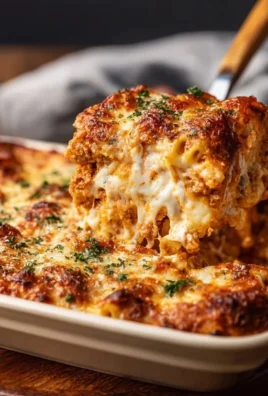 Delicious Chicken Parmesan Casserole topped with cheese and herbs