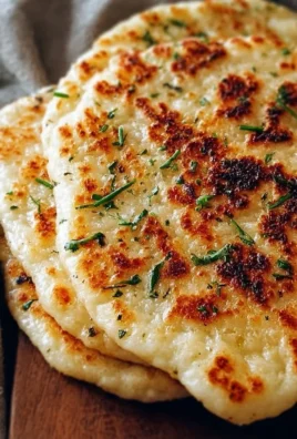 A delicious cottage cheese flatbread served on a plate with toppings.