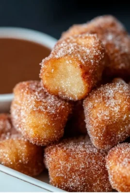 Delicious crispy air fryer churro bites served with chocolate sauce