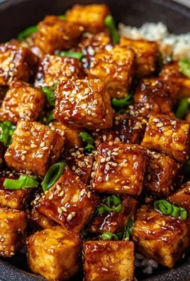 Crispy honey garlic tofu served on a plate with garnishes