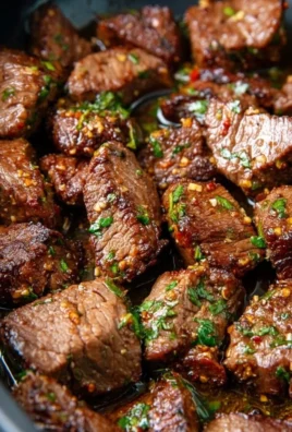 Delicious garlic butter steak bites served on a plate with herbs