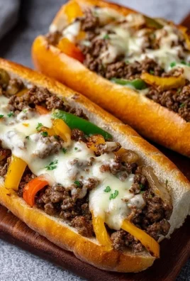 Ground Beef Philly Cheesesteaks served with melted cheese and peppers