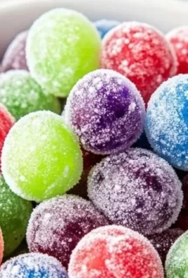 Colorful Kool Aid grapes coated in flavored powder for a delicious treat