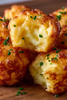 Cheesy leftover mashed potato puffs served on a plate.