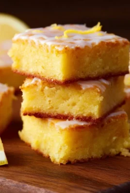 Freshly baked lemon brownies with a glossy lemon glaze on top