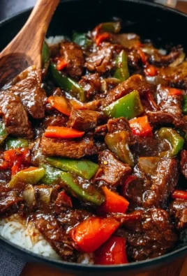 Delicious homemade pepper steak served with vegetables and rice.