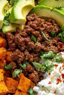 Colorful sweet potato taco bowl topped with fresh veggies and ingredients