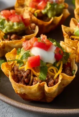 Taco cups filled with vibrant toppings and served on a platter