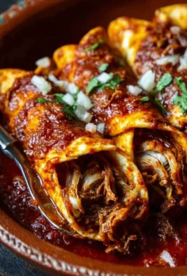 Delicious birria enchiladas garnished with fresh cilantro and onions