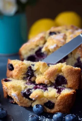 Delicious Blueberry Lemon Loaf with blueberries and lemon zest on a platter