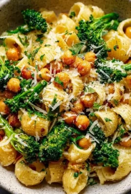 Bowl of Broccoli Chickpea Pasta with Garlic Olive Oil garnished with herbs.