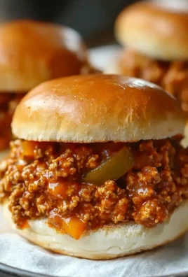 Cajun Chicken Sloppy Joes served on a wooden board with fresh ingredients.