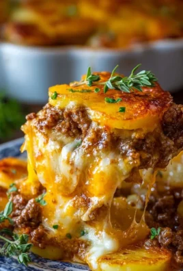 Cheesy Hamburger Potato Casserole topped with melted cheese and herbs