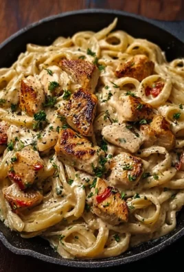 Plate of creamy Cajun chicken pasta garnished with herbs and spices