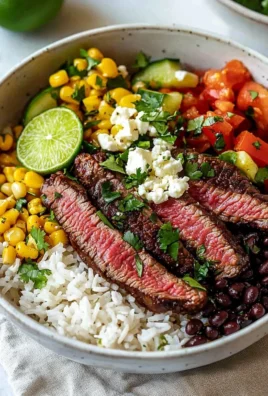 Delicious Flank Steak Bowl garnished with fresh vegetables and herbs.