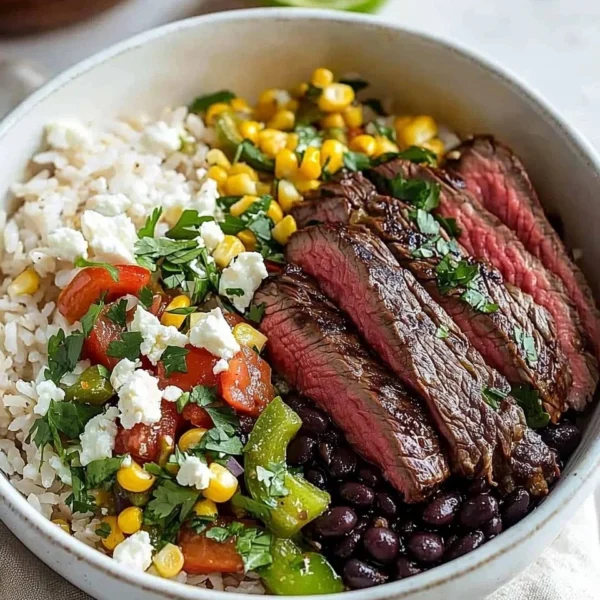 Delicious Flank Steak Bowl with fresh vegetables and flavorful dressing