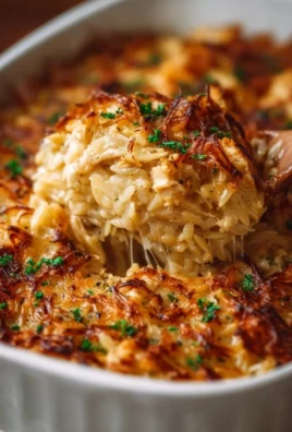 Delicious French Onion Chicken Orzo Casserole topped with melty cheese and herbs.