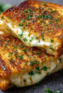 Melted cheese between slices of garlic bread, a tasty grilled cheese sandwich.