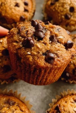 Baked healthy chocolate chip oat muffins on a cooling rack