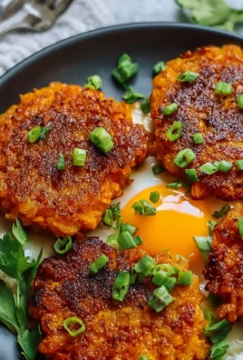 Healthy sweet potato hash browns served on a plate with herbs and spices