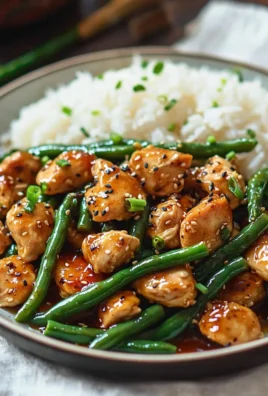 Delicious honey garlic chicken served with fresh green beans on a plate