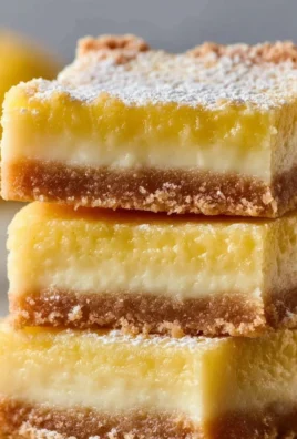 Delicious lemon bars made with condensed milk, topped with powdered sugar.