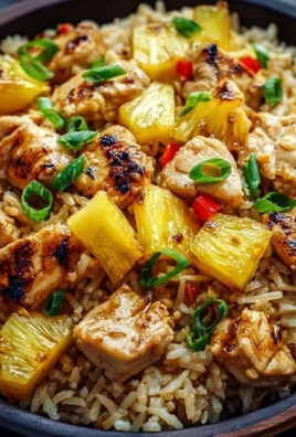 Delicious pineapple chicken served with rice, garnished with fresh herbs