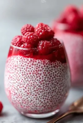 Raspberry Chia Pudding topped with fresh raspberries and maple syrup.