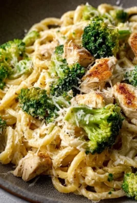 Rotisserie chicken broccoli pasta dish garnished with fresh herbs
