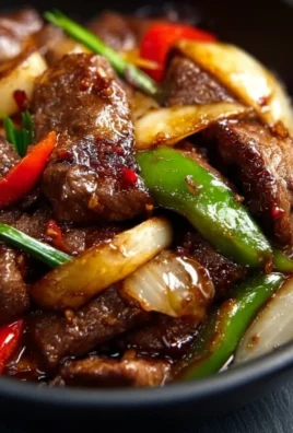 Sizzling Chinese pepper steak with onions served on a plate