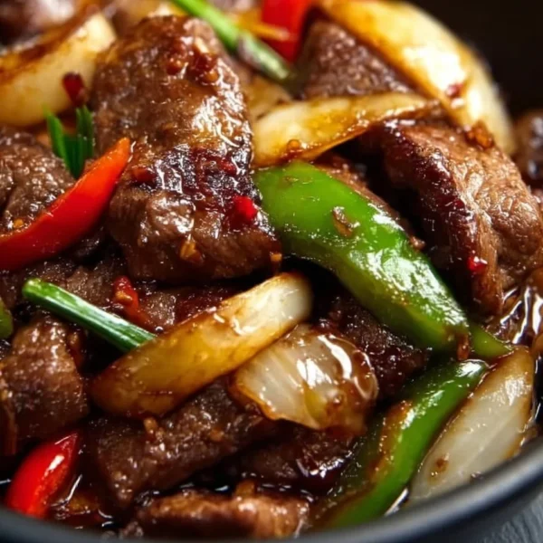 Sizzling Chinese pepper steak with onions served on a plate