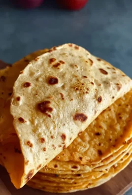 Homemade sweet potato tortillas on a rustic wooden table.