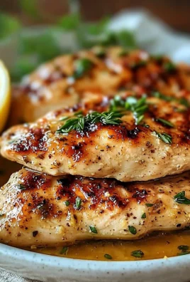 Tenderized chicken breast ready for cooking with herbs and spices.