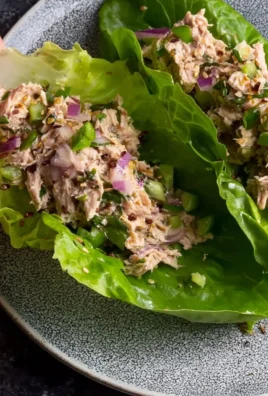 Freshly made tuna lettuce wraps filled with veggies and tuna salad
