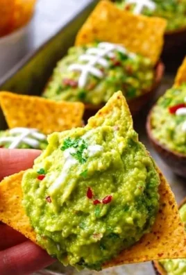 Avocado guacamole served in a football-themed bowl for gameday festivities.