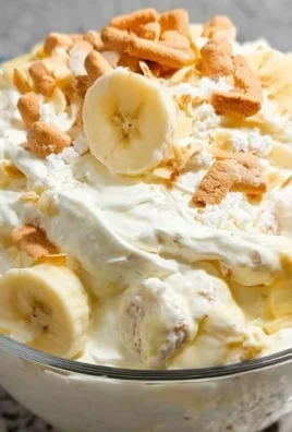 Delicious Banana Pudding Fluff Salad in a serving bowl with whipped cream and bananas