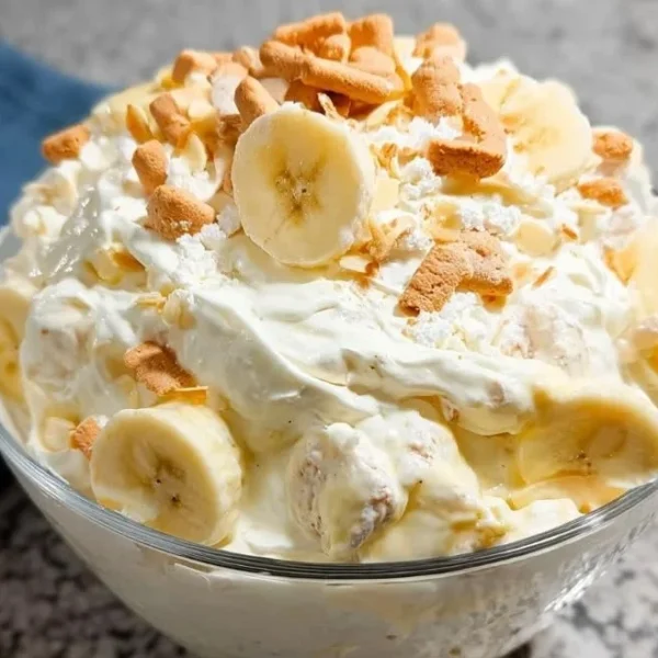 Delicious Banana Pudding Fluff Salad in a serving bowl with whipped cream and bananas