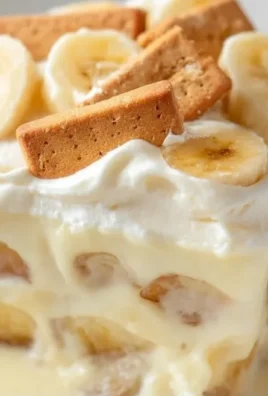 Delicious Chessman Banana Pudding in a glass dish with layers of bananas and cookies.