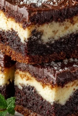 Decadent chocolate sugar cookie bars topped with chocolate drizzle