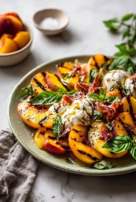 Classic grilled peach burrata served with prosciutto on a plate