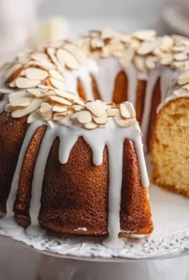 Freshly baked classic pound cake, golden and moist, served on a white plate.