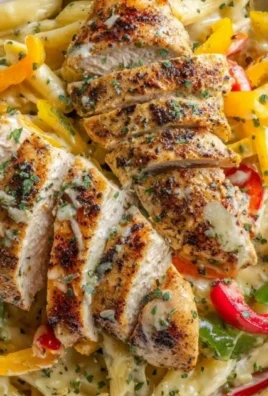 Creamy jerk chicken rasta pasta in a bowl with herbs and spices