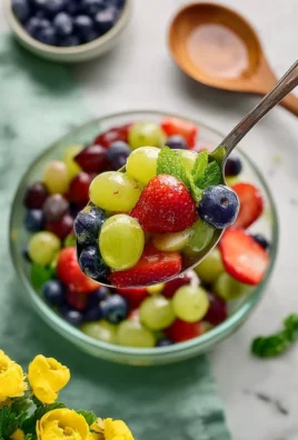 Colorful fruit salad topped with zesty lemon dressing
