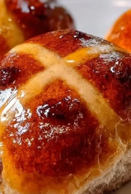 Golden Apple Hot Cross Buns fresh out of the oven, adorned with a cross and apple slices
