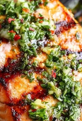 Grilled salmon fillet topped with vibrant chimichurri sauce