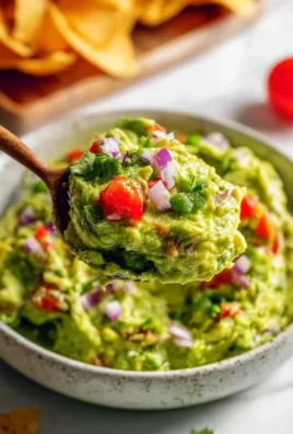 Delicious homemade guacamole with fresh ingredients and vibrant colors.